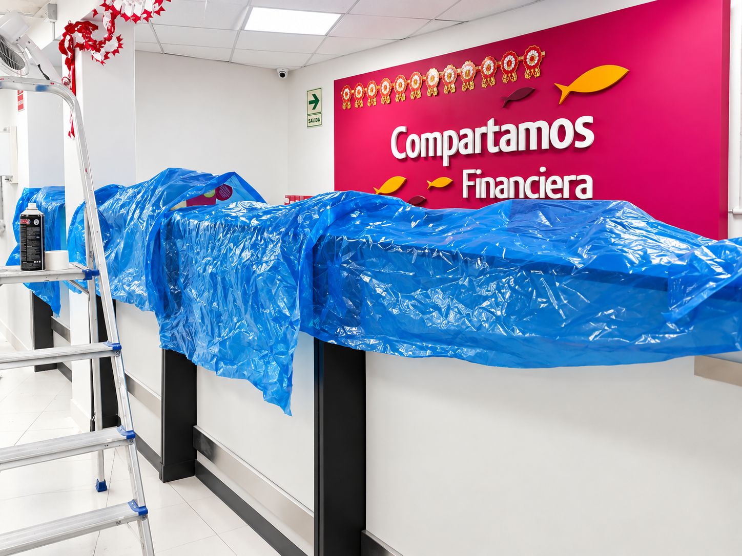 Mostrador de una agencia de Compartamos Financiera cubierto con plástico protector durante los trabajos.